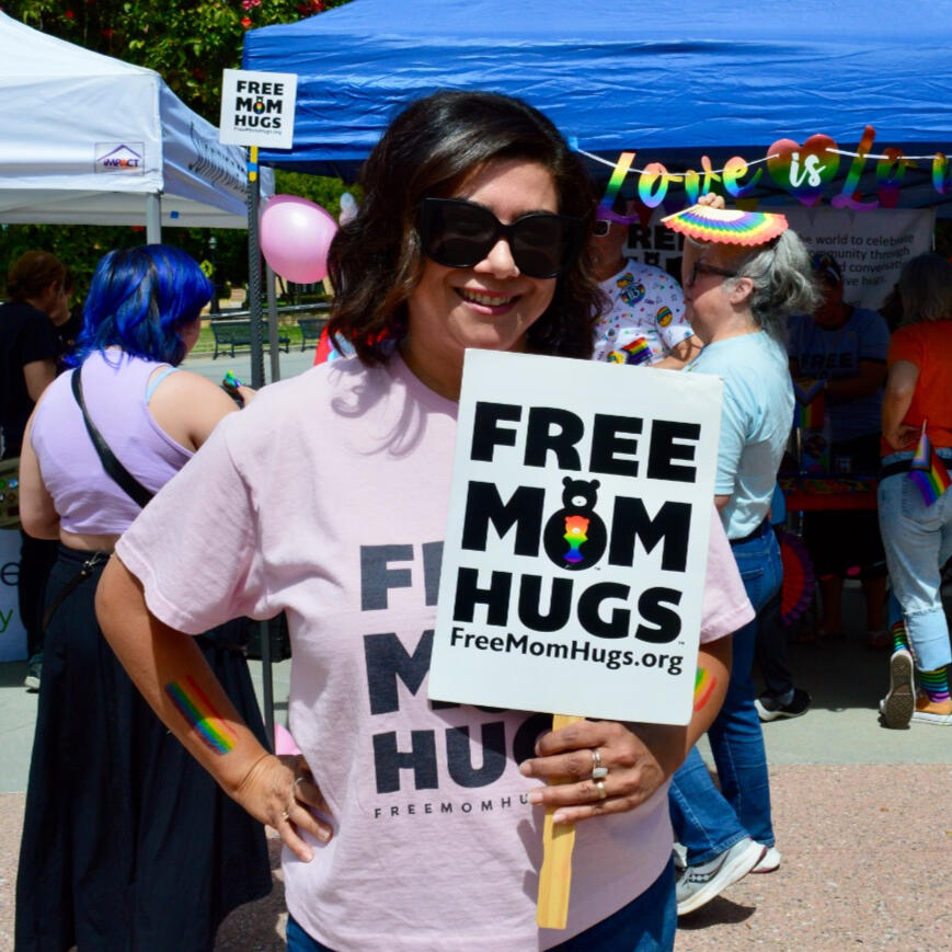 Mom Hugs Woman holding a "free mom hugs" sign